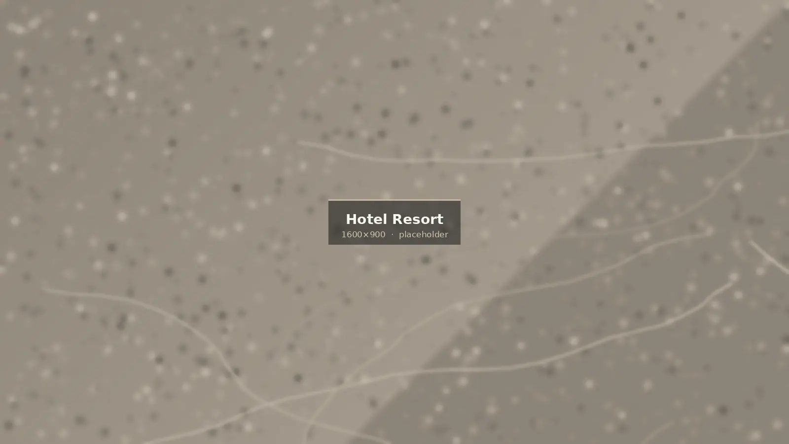 Natural stone used across a resort — pool, lobby and landscape in one material palette